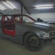 Grey BMW E36 Track Car With Red Roll Cage And Black Wheels